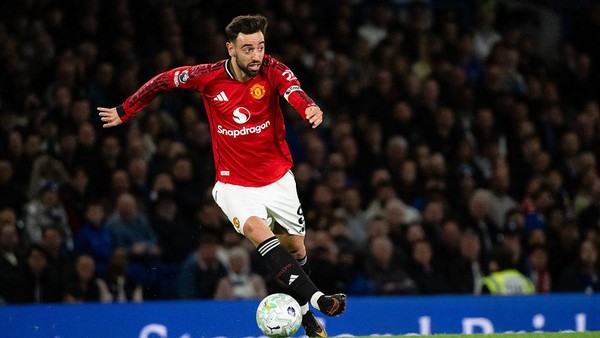 Bruno Fernandes sedang menendang bola dalam pertandingan Manchester United.