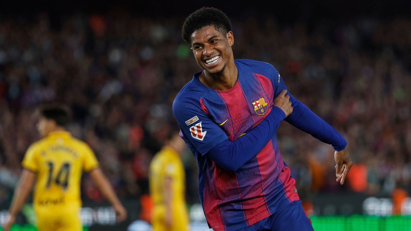 Marcus Rashford tersenyum saat bertanding mengenakan jersey Barcelona