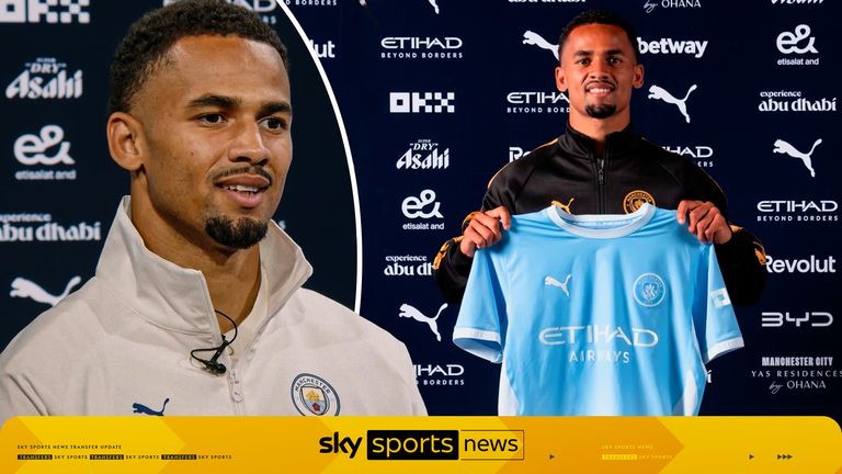 Iliman Ndiaye diperkenalkan sebagai pemain baru Manchester City sambil memegang jersey tim.